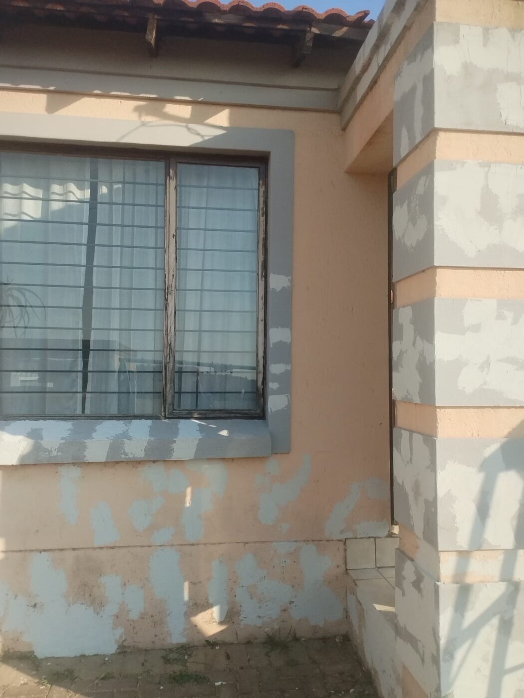 Window surround and decorative pillar prepared with filler before painting.